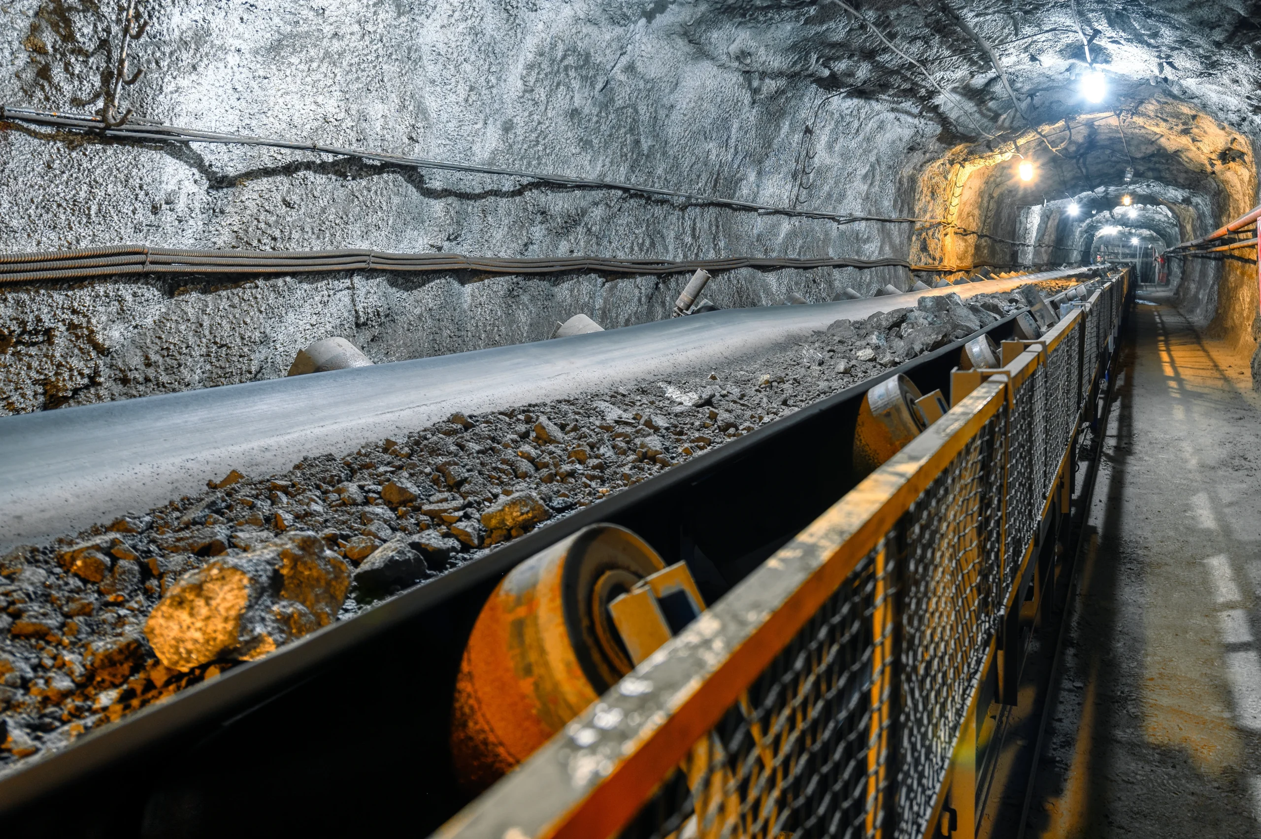 Belt conveyor in an underground tunnel. Transportation of ore to the surface